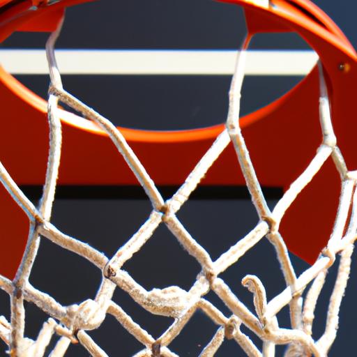 Một góc chụp cận cảnh của trụ bóng rổ và lưới. Trụ bóng rổ được làm bằng kim loại màu cam và lưới được làm bằng vật liệu lưới trắng.